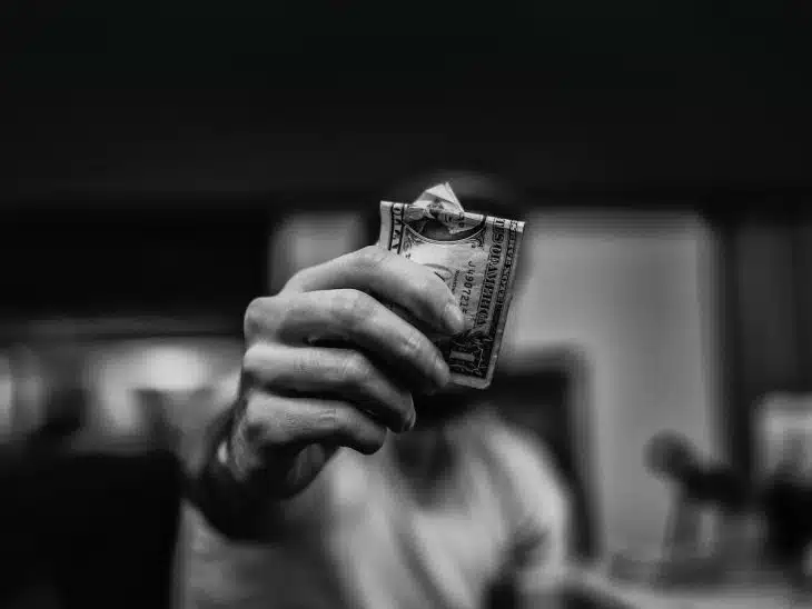 man holding 1 US dollar banknote